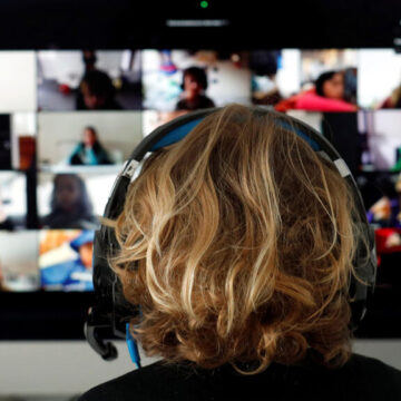 A student takes classes online with his companions using the Zoom APP at home